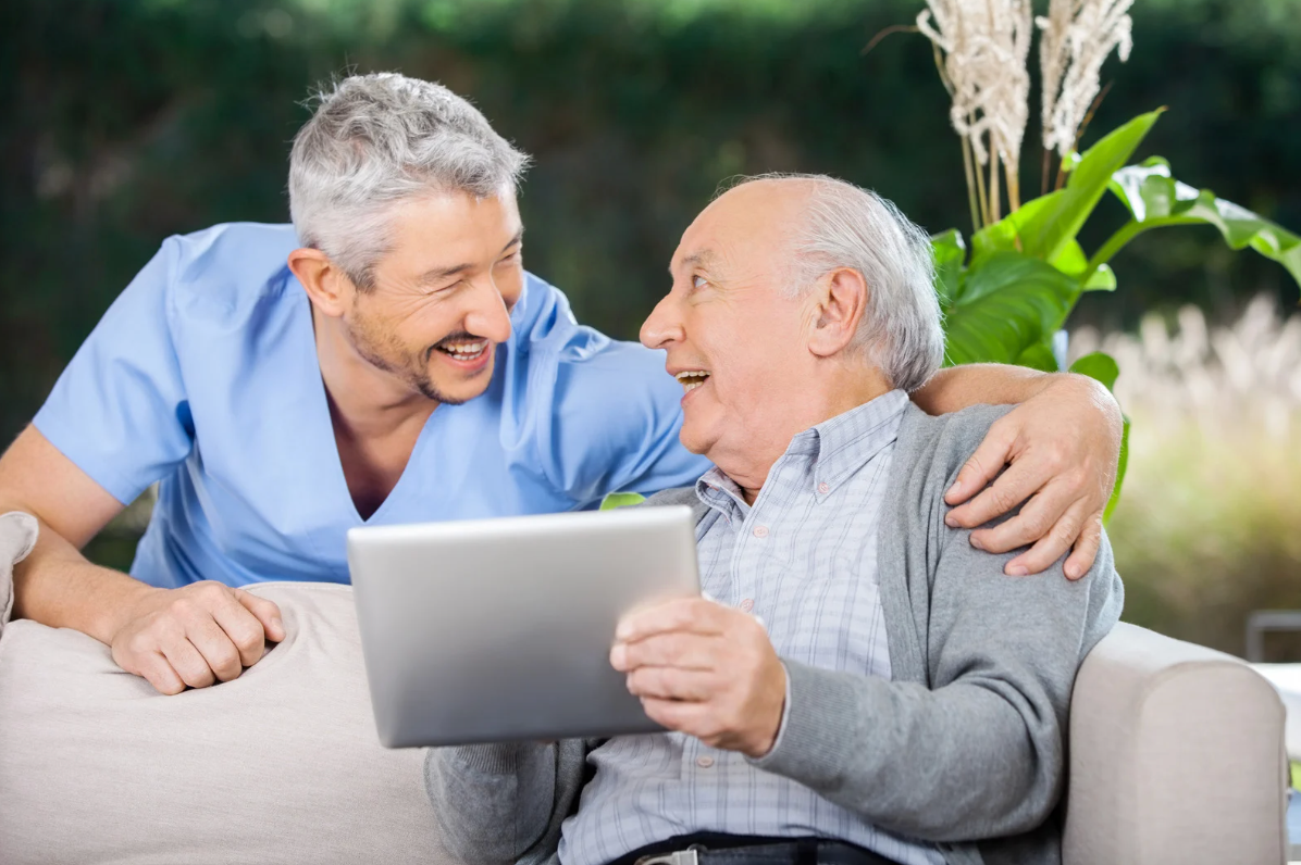 Male Nurse Helping Senior with Technology