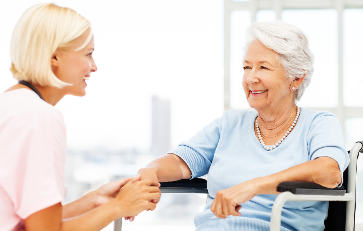 Elderly woman smiling with pearls