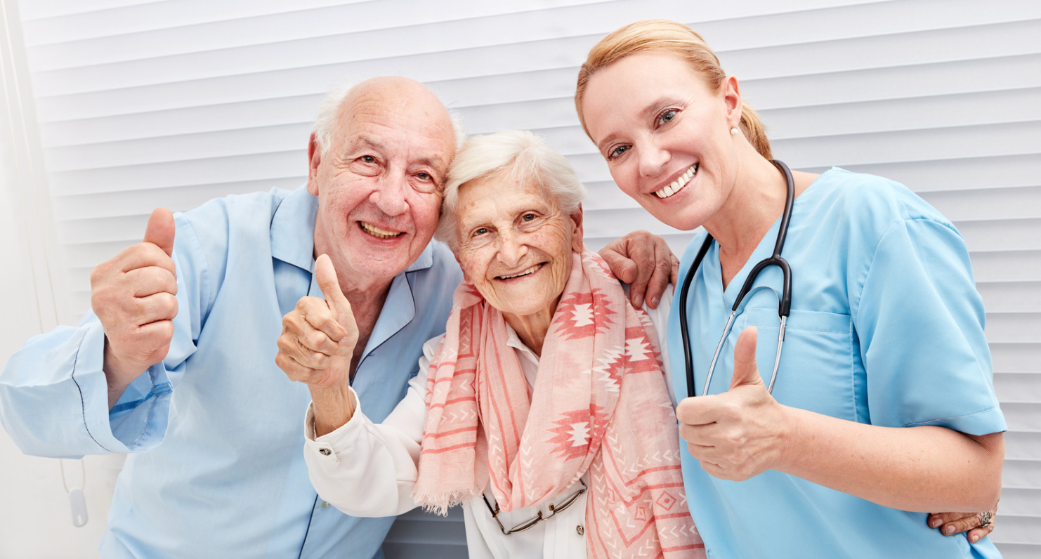 Elderly couple with thumbs up for good home care service